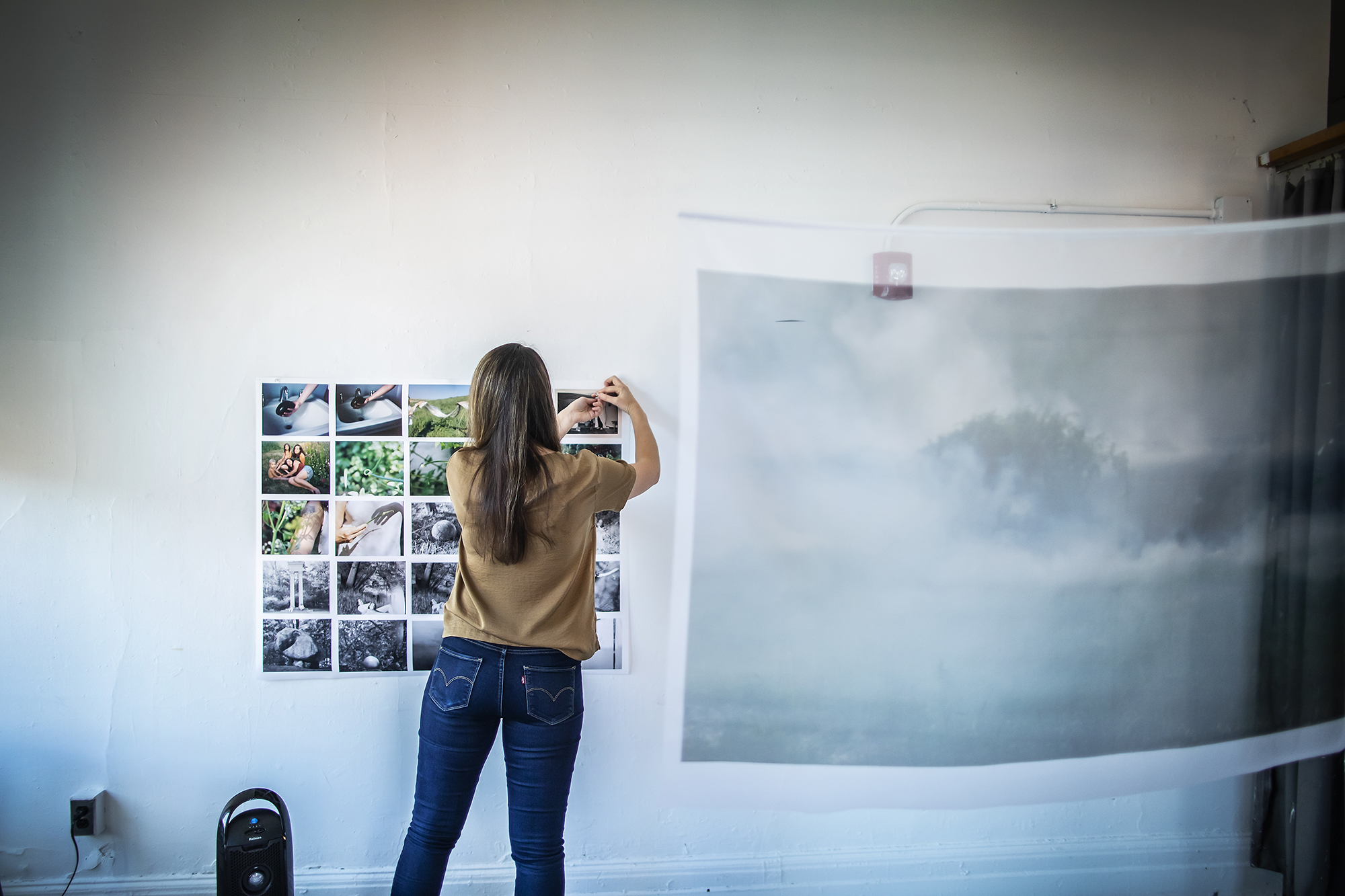 Amrita Stützle is seen working in the studio proof printing a selection of photographs.