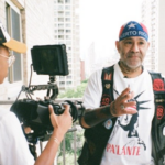 Director of Photography Morgan Powell films main character Chino Familia on an Upper West Side balcony. He's wearing a Puerto Rican flag head cap and clothes symbolizing the island's independence movement.