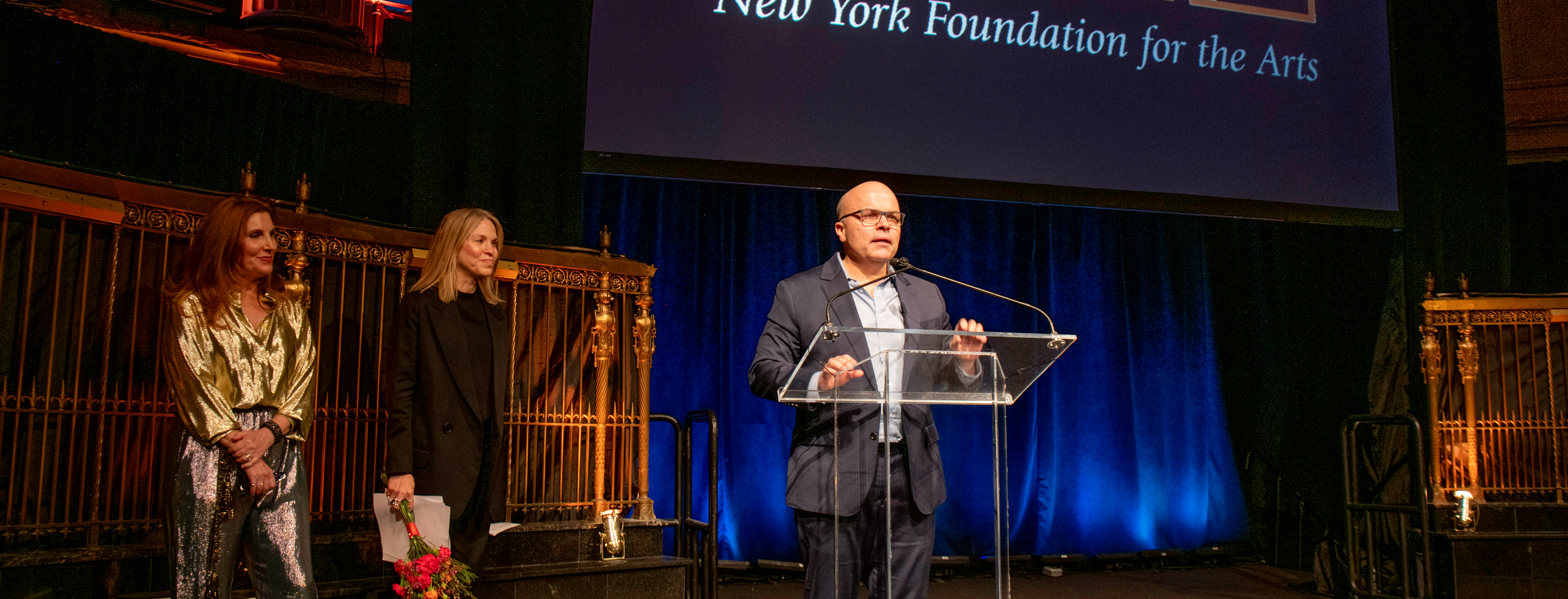 JT Rogers behind the podium at NYFA's 2025 Hall of Fame Benefit